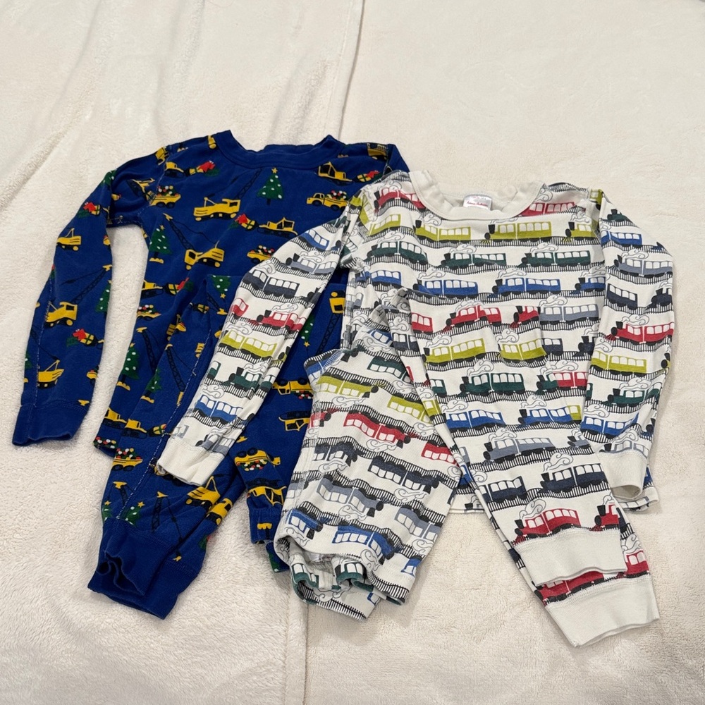 HANNA ANDERSON pajama sets. Size 8. Trains and Christmas construction vehicles.